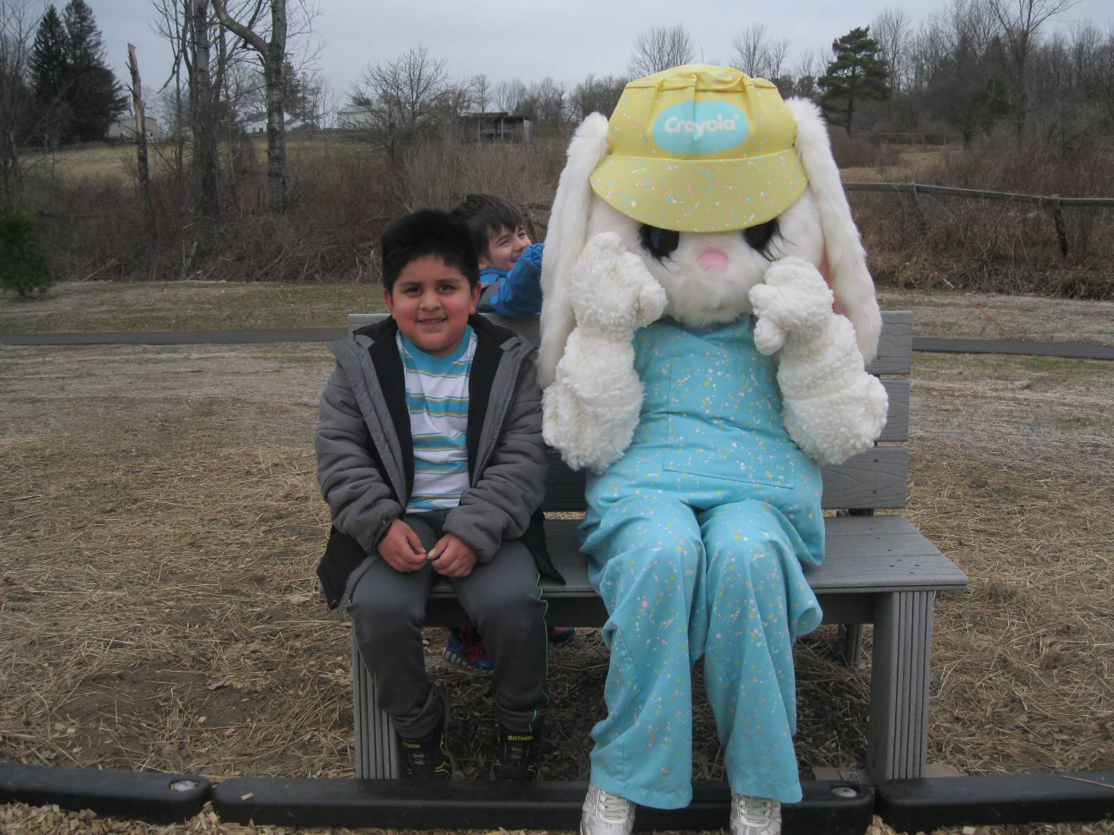 A student smiles with Easter Bunny.