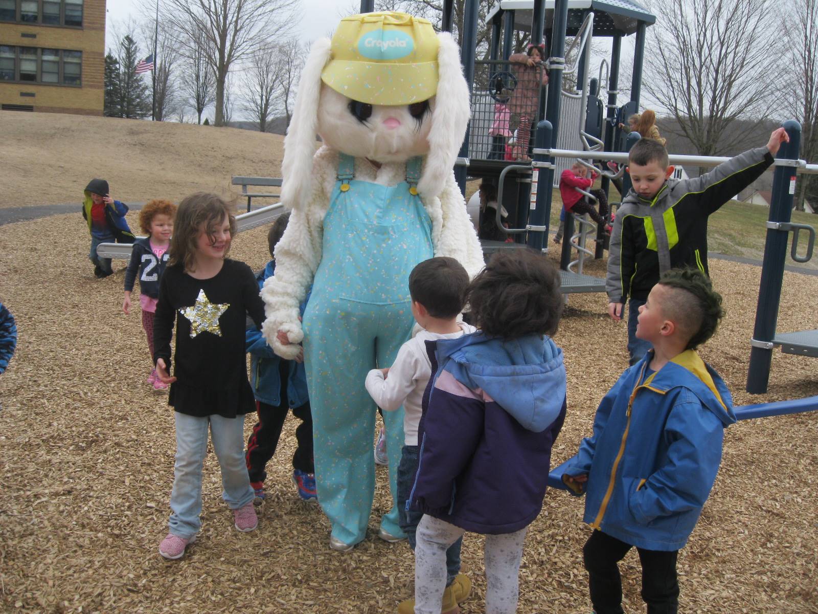 Students show Easter Bunny around the playground.