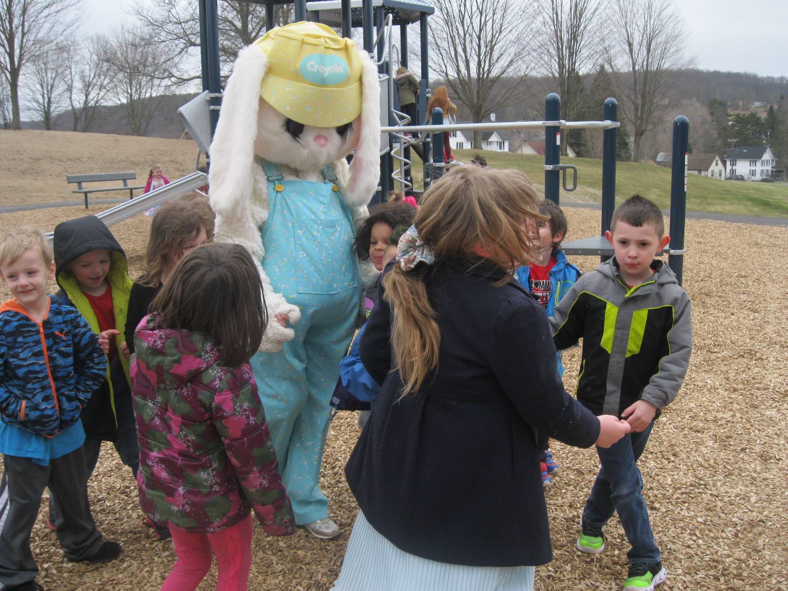 Students show Easter Bunny around the playground.