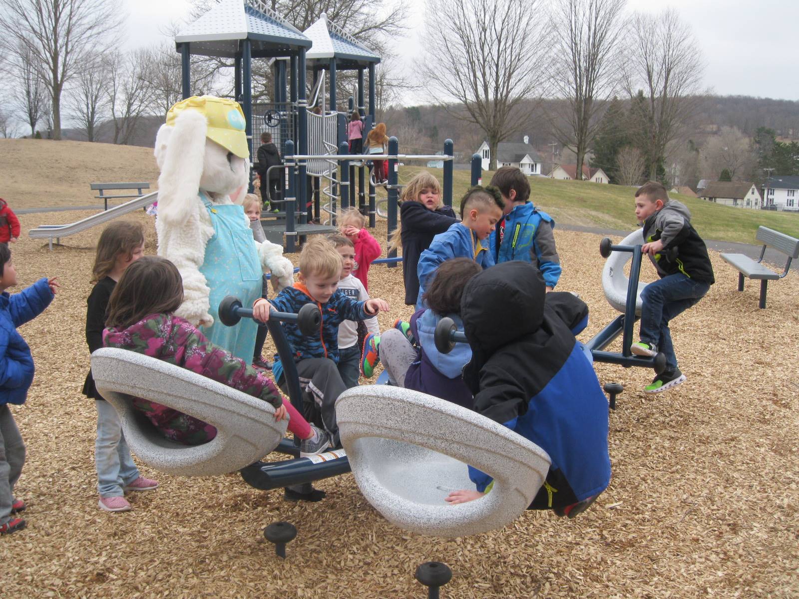 Students show Easter Bunny around the playground.
