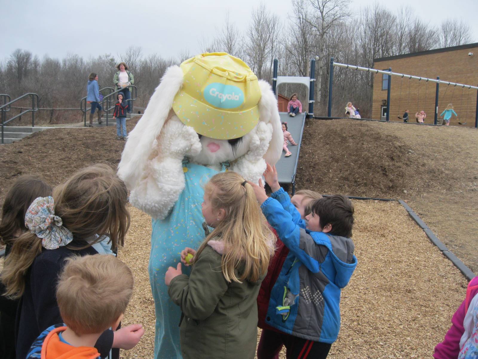 Easter Bunny plays peek a boo with students.