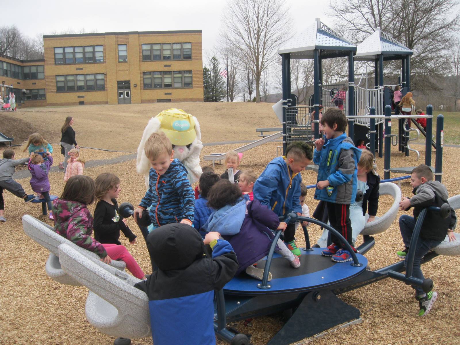 Students show Easter Bunny around the playground.