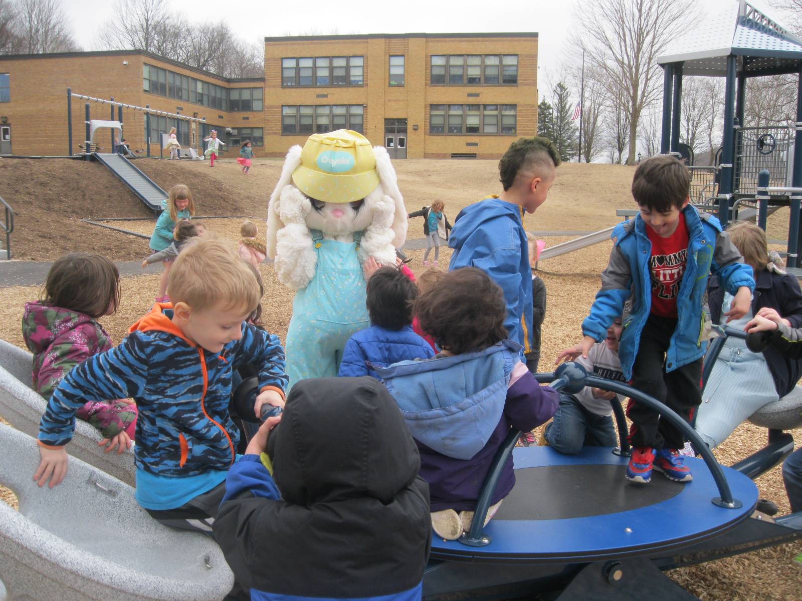 Students show Easter Bunny around the playground.