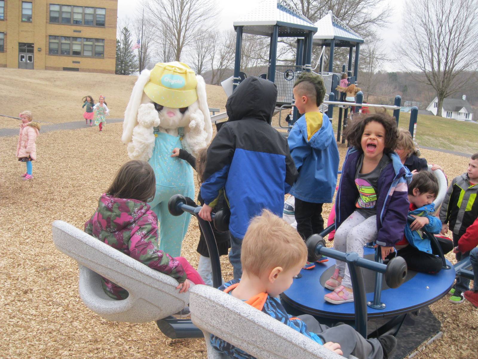 Students show Easter Bunny around the playground.