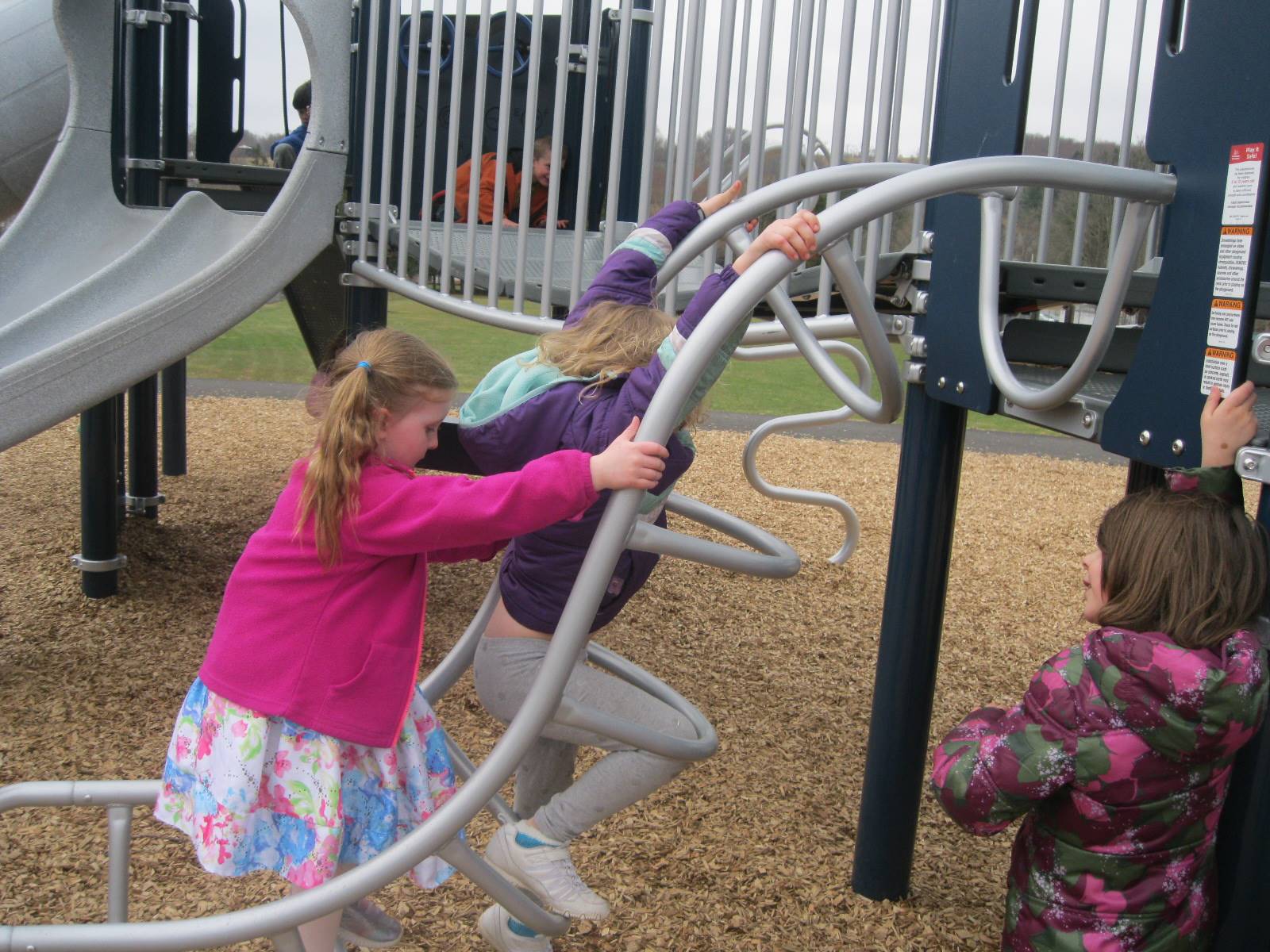 Students climb on playground.