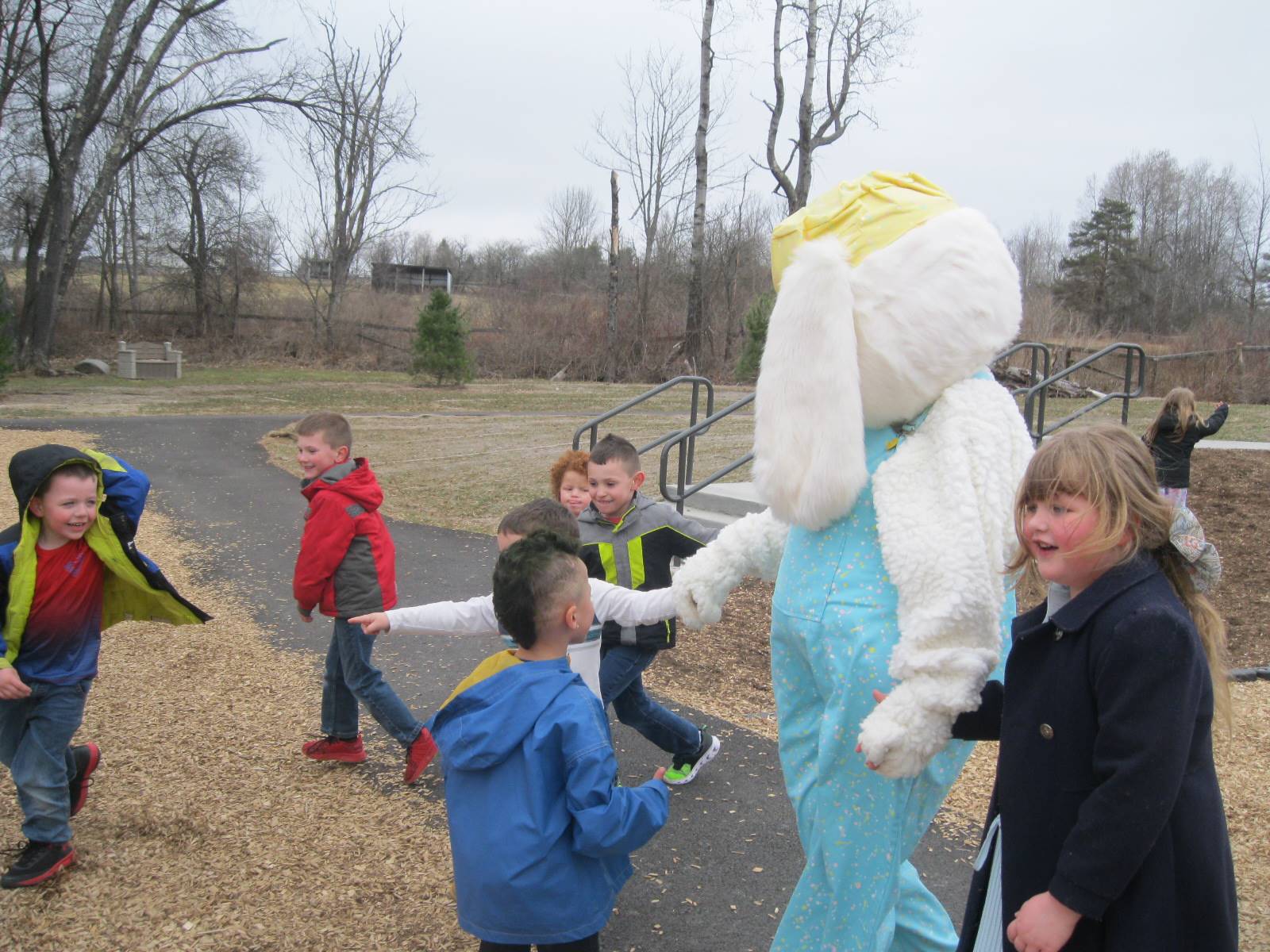 Students show Easter Bunny around the playground.