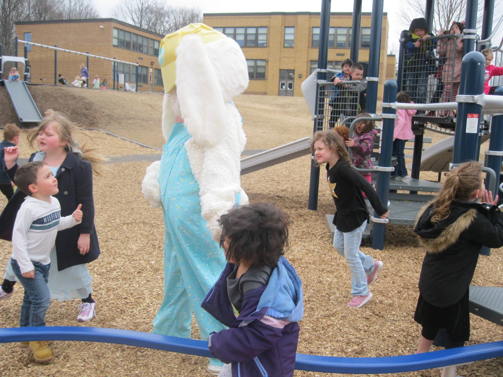 Students show Easter Bunny around the playground.