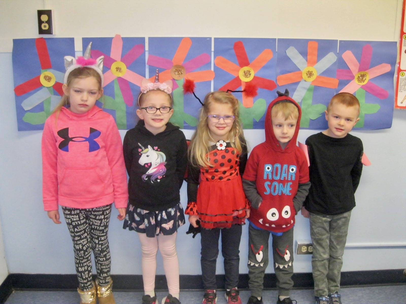 5 students dressed up for Read Across America.