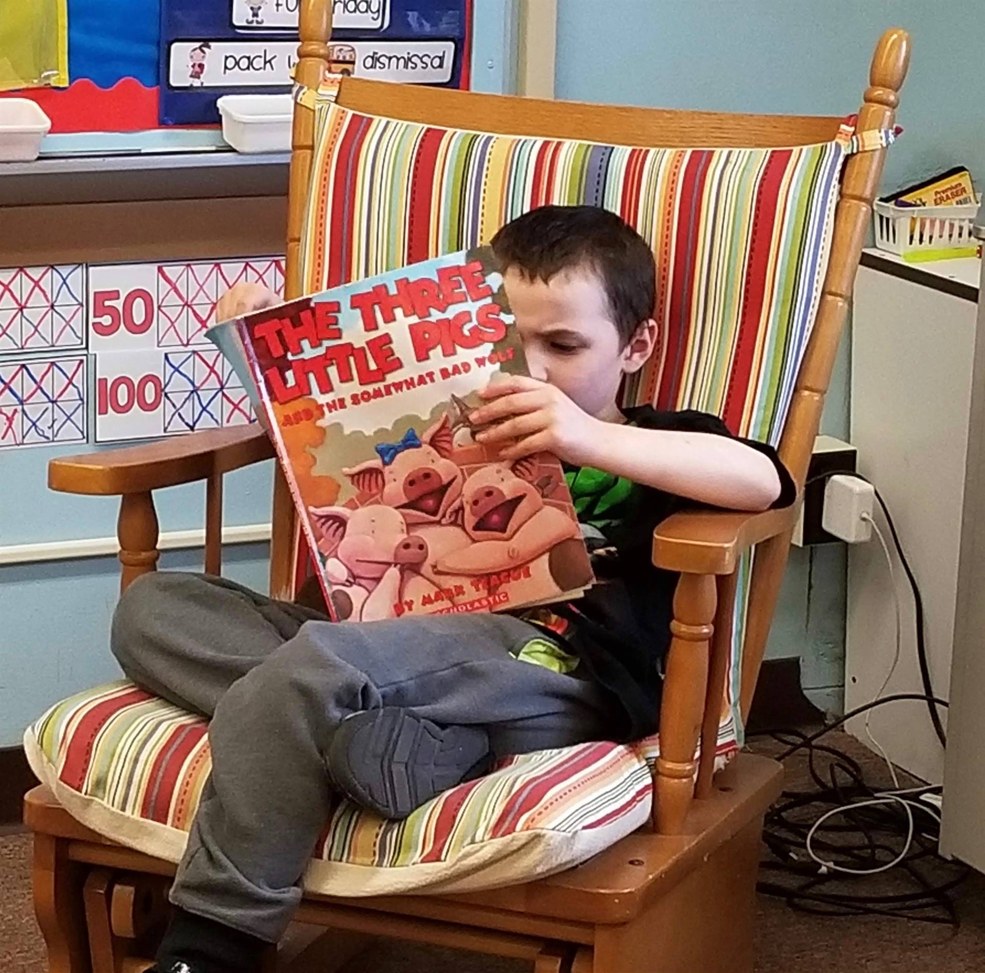 A student reads in a rocking chair.