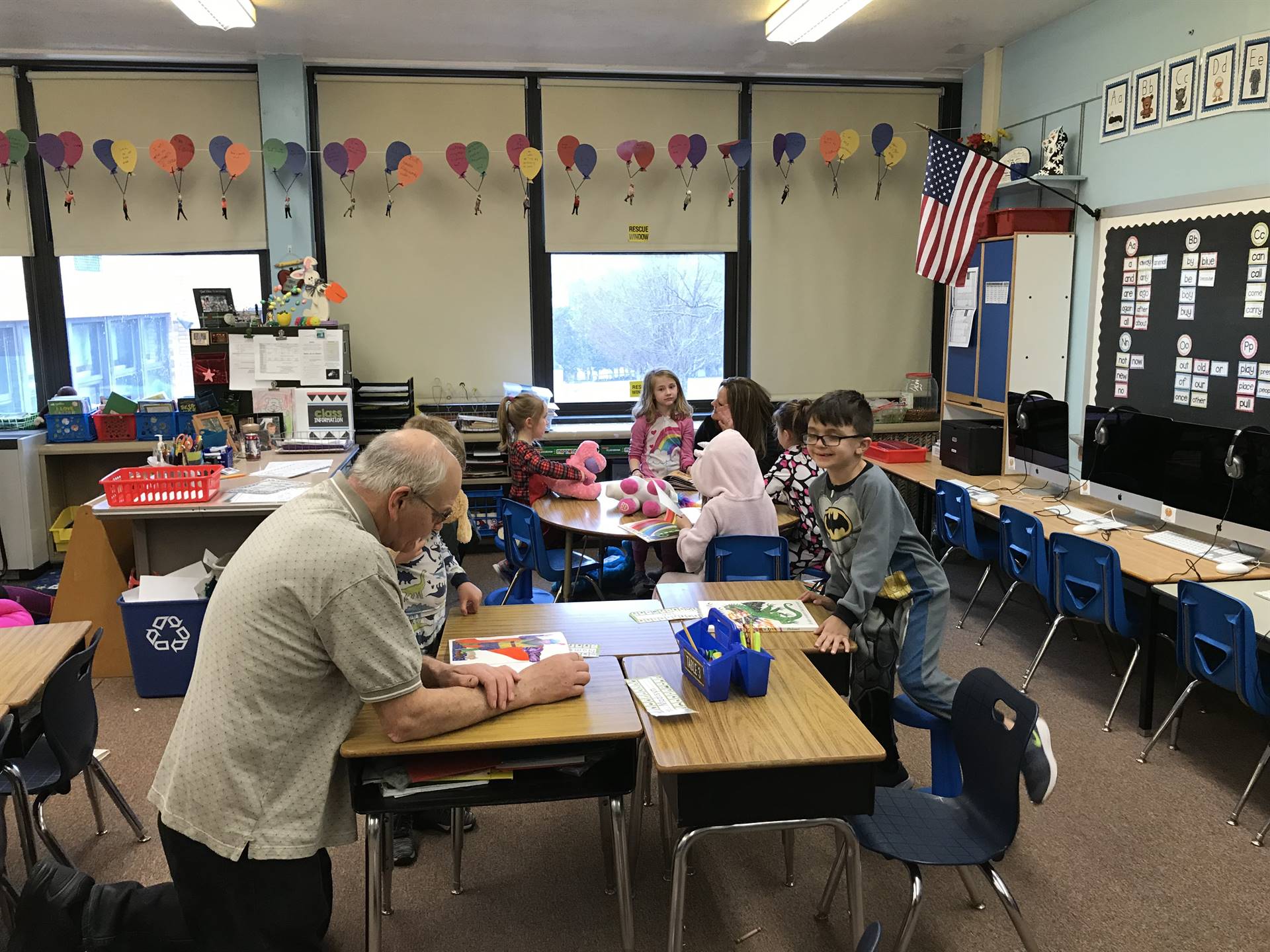 Grandparents and parents read with students.