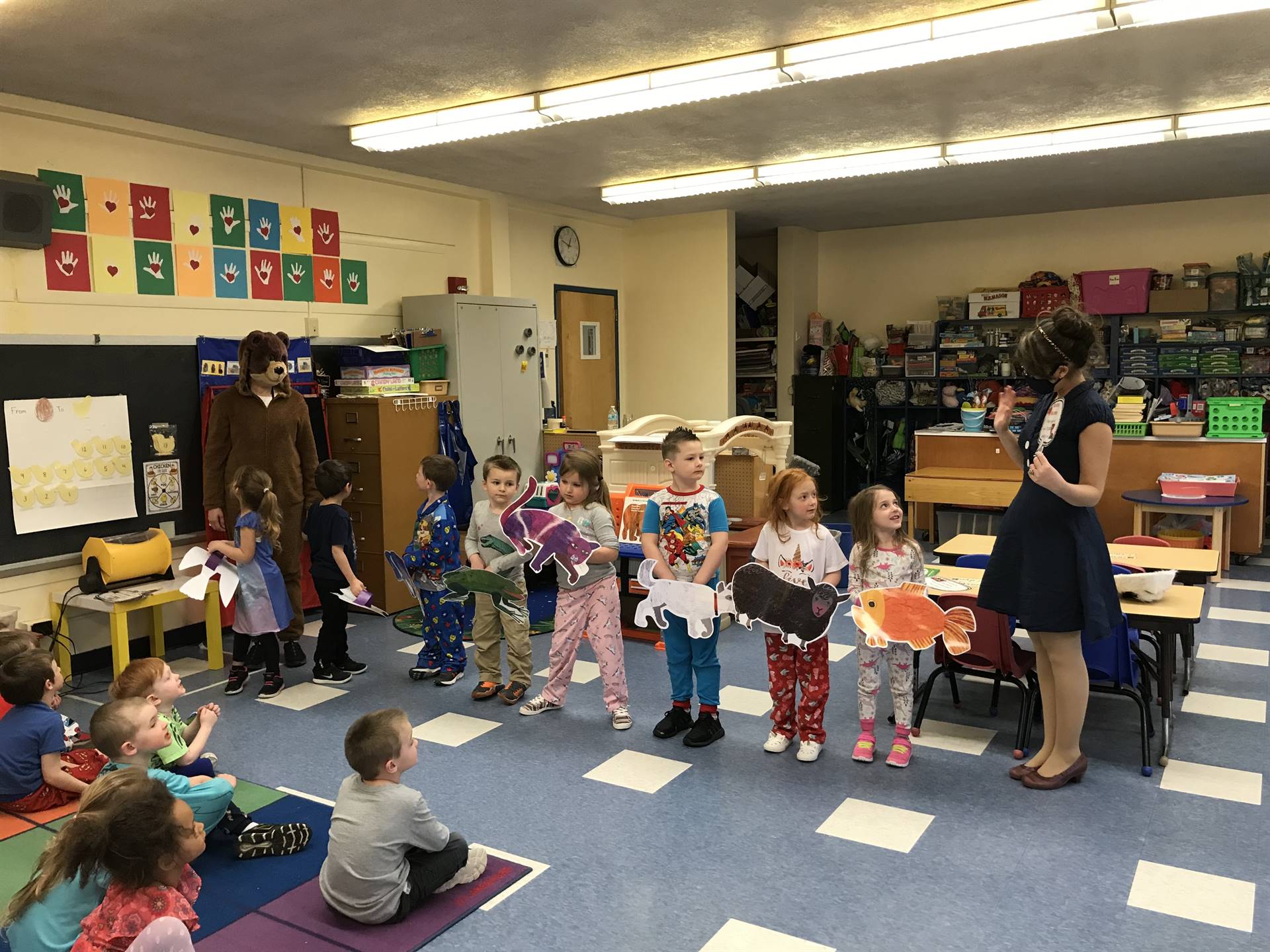 Pre K class and Mrs. Seliga act out a story.