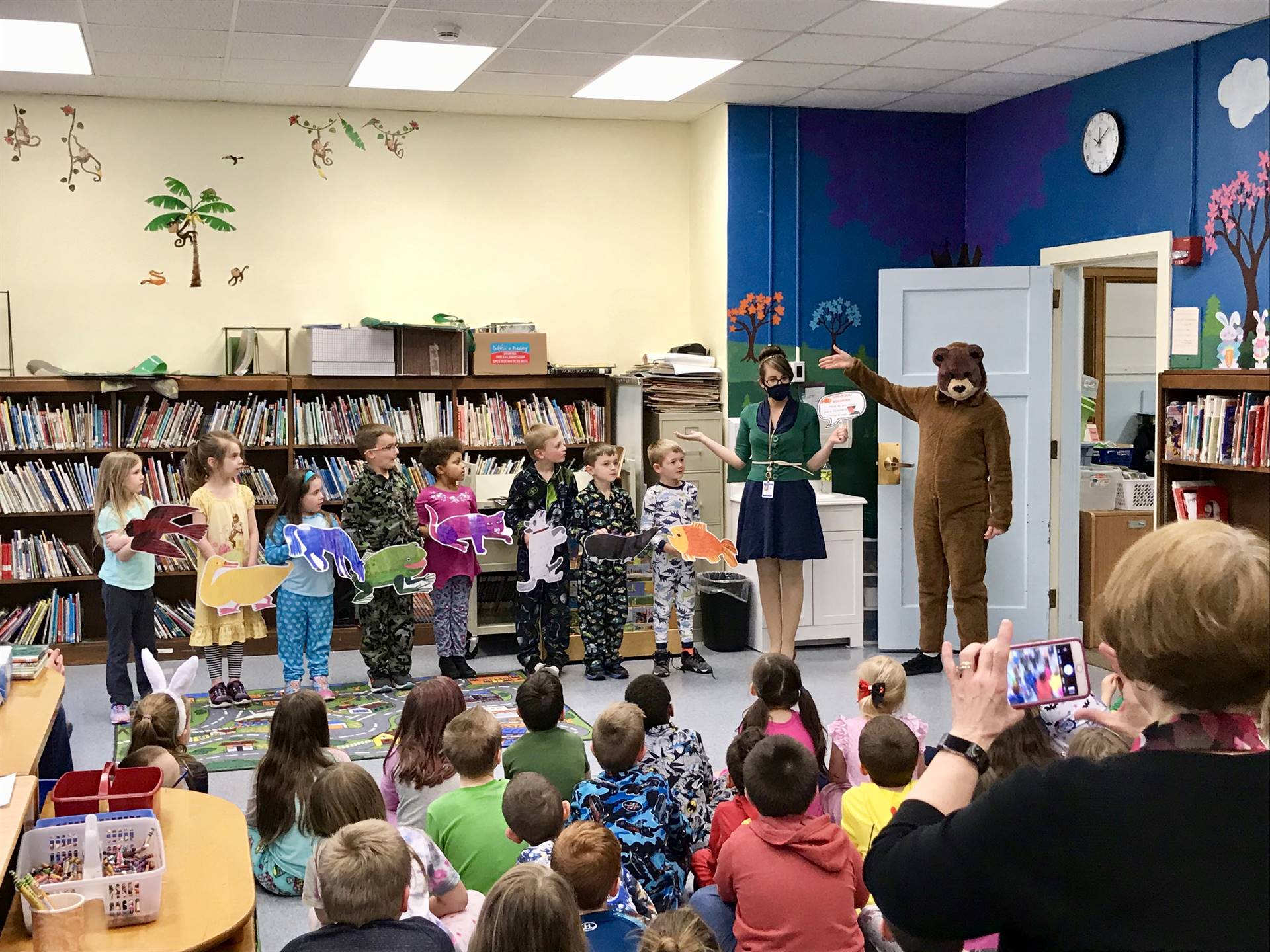 First grade students with Brown Bear and a teacher.