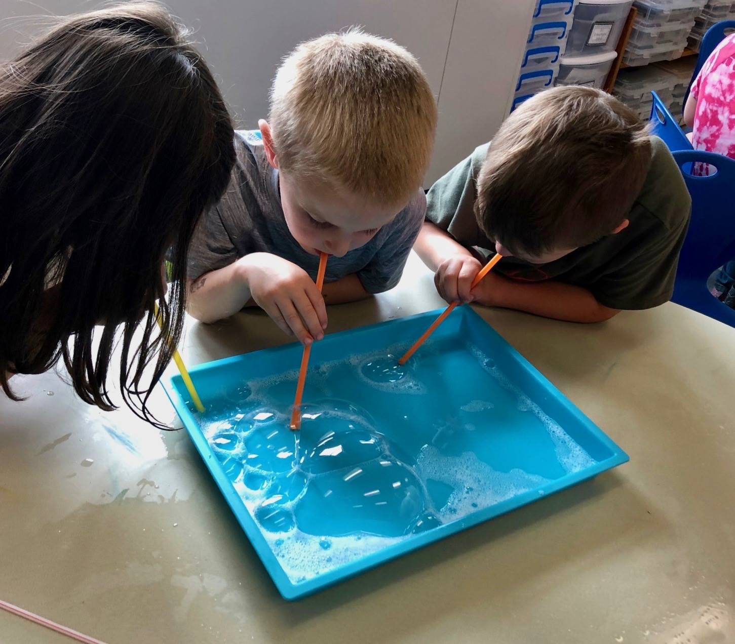 3 students doing bubble painting.