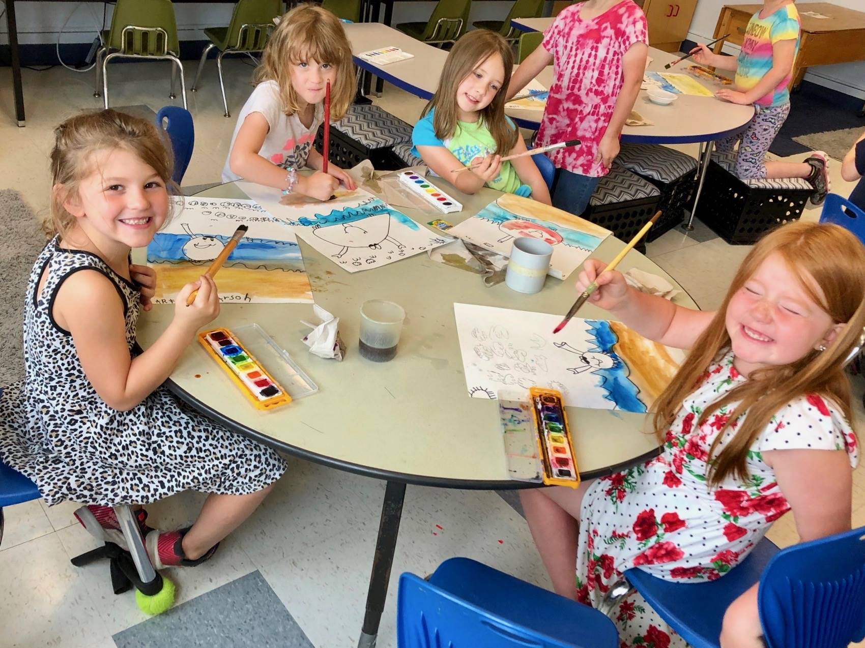 4 students show how bubbles mixed with paint looks.