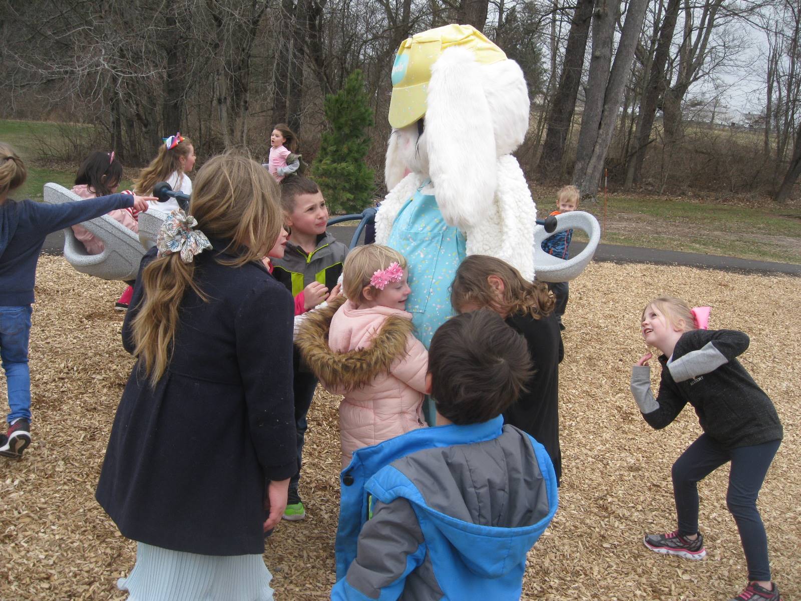 Students give hugs to the Easter Bunny
