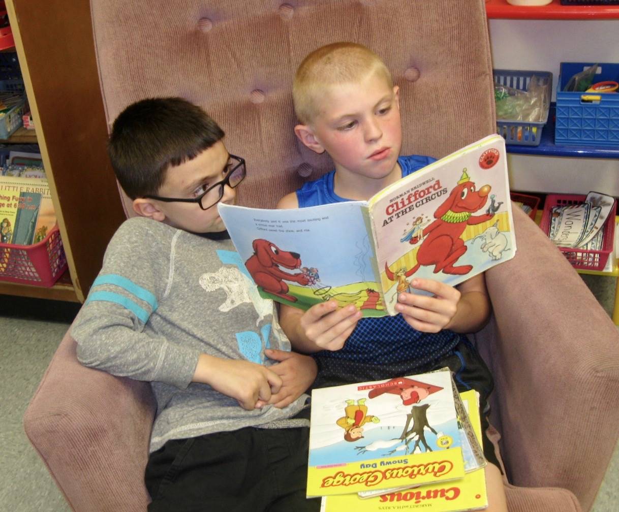 2nd grader reading to 1st grader