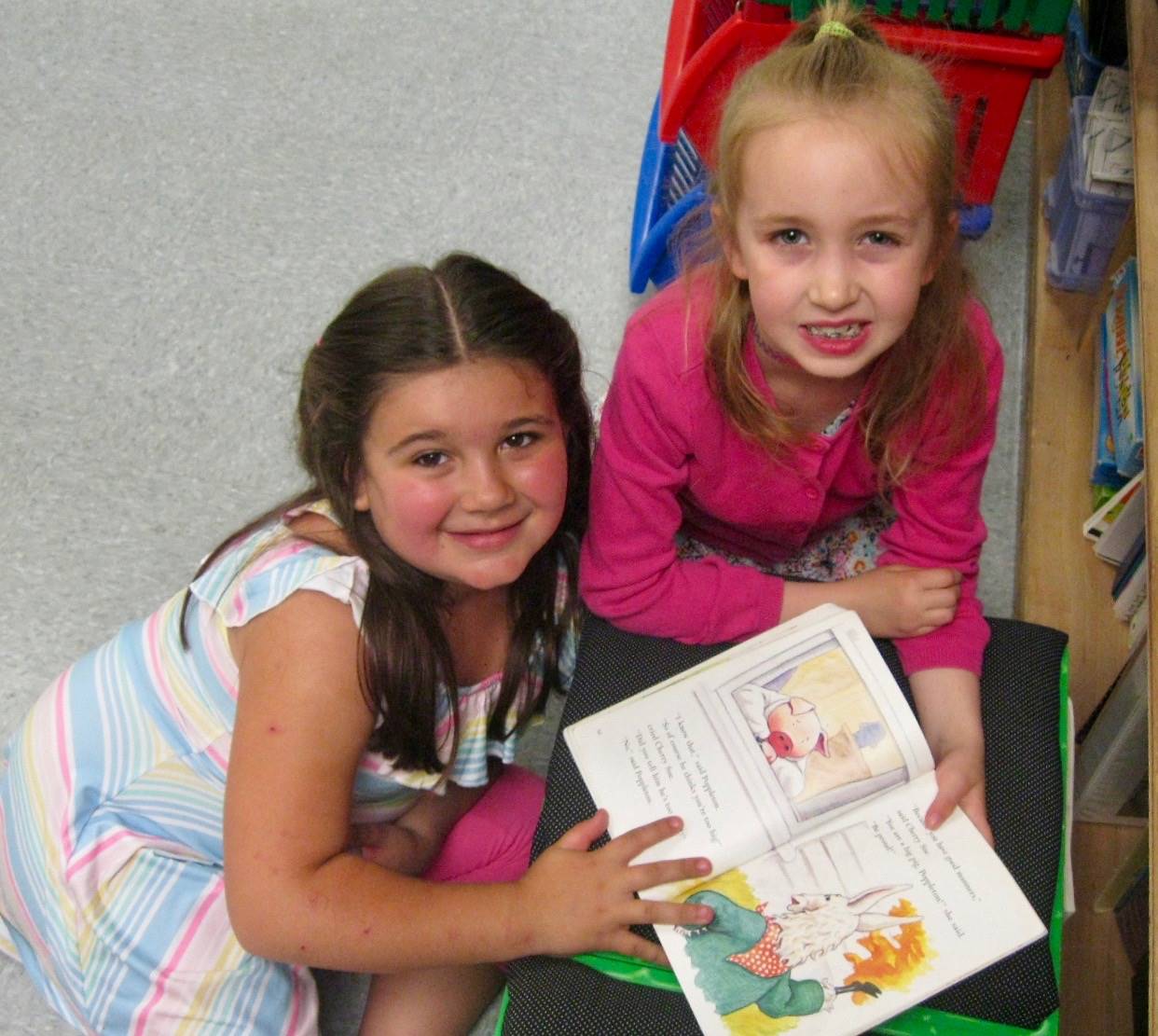 2nd grader reading to 1st grader