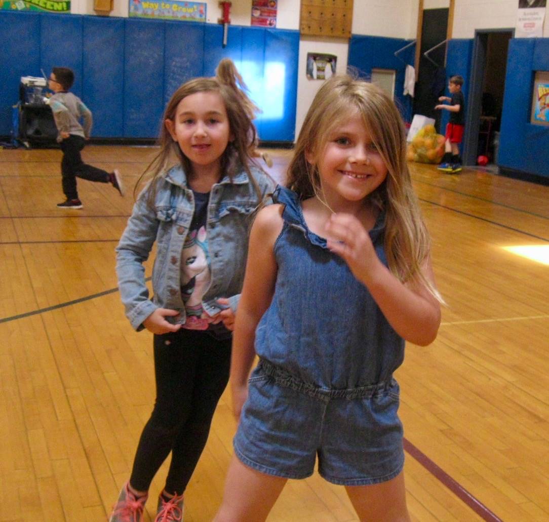 2 students playing mud tag and helping.