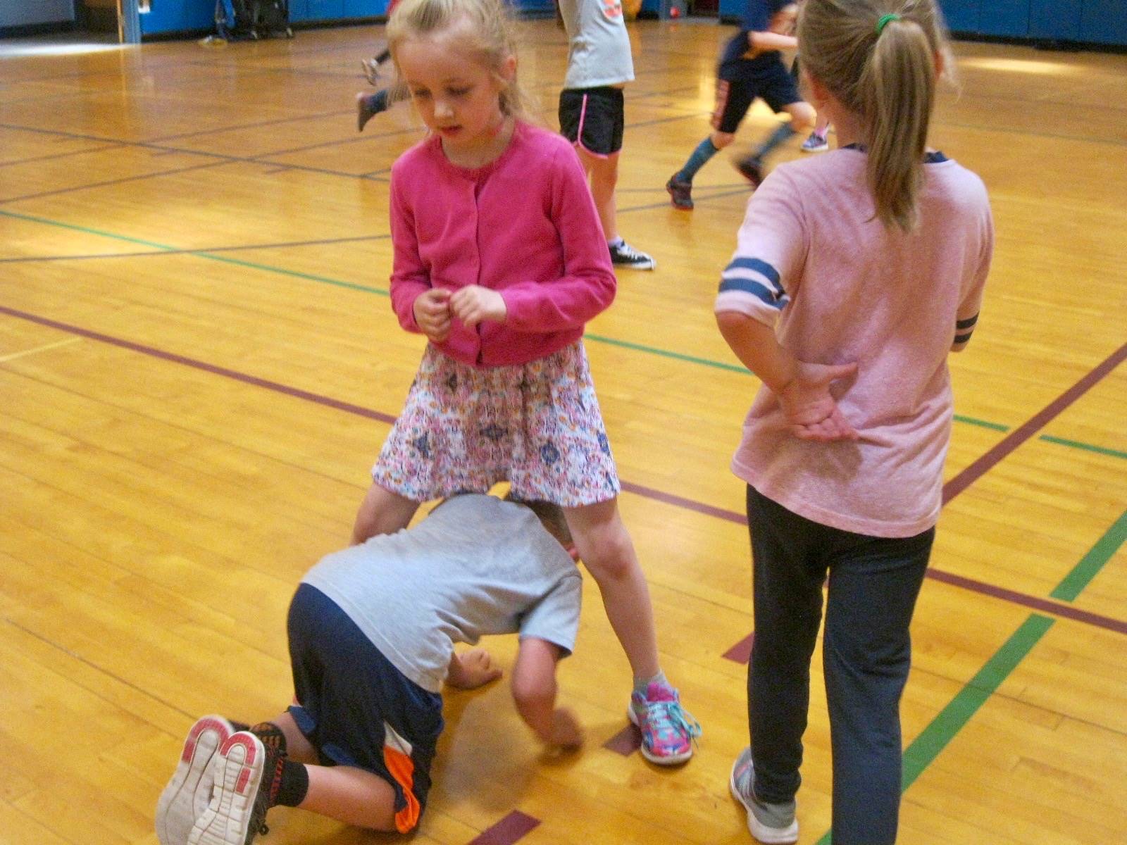 3 Students play mudtag in PE.