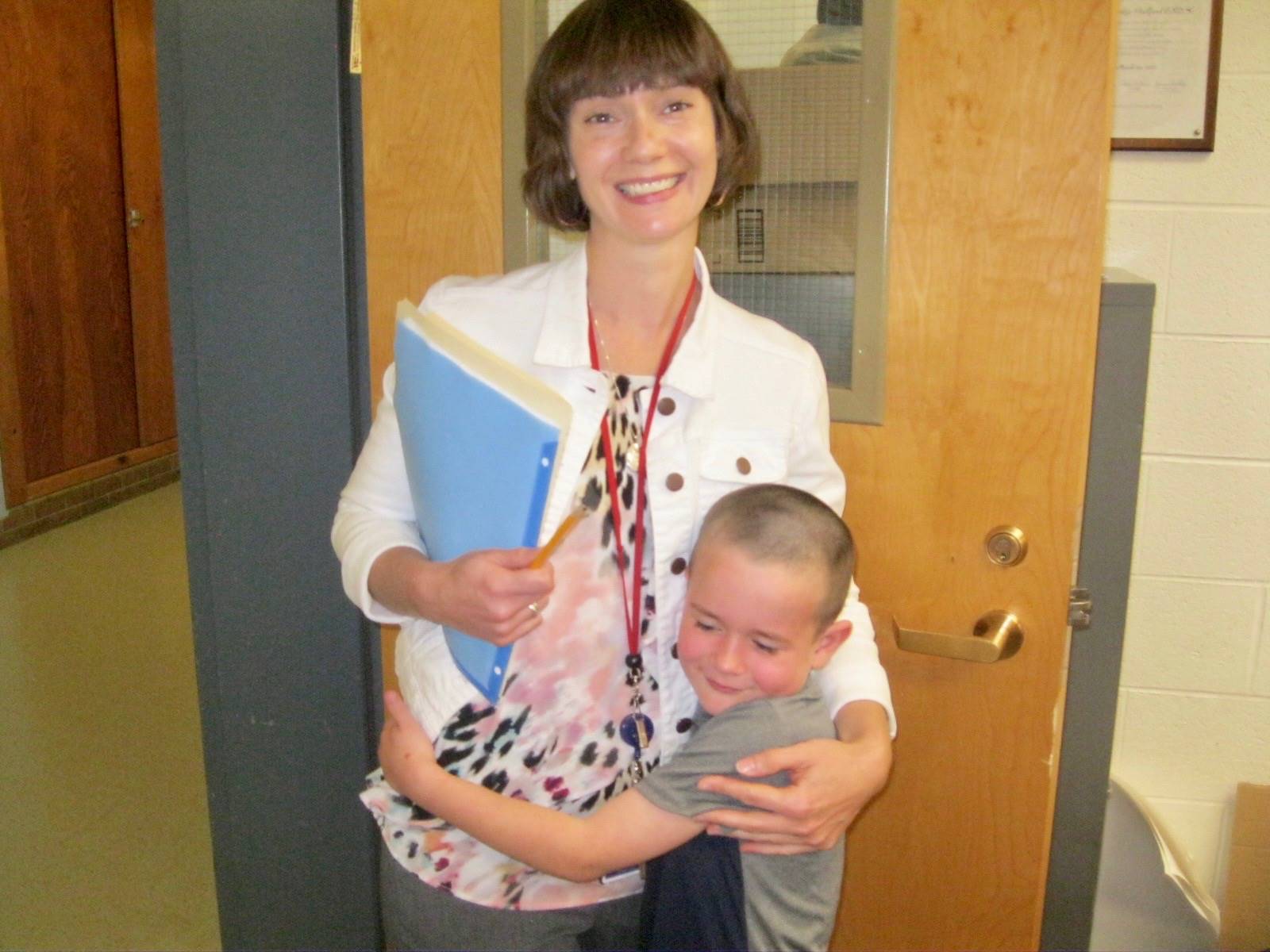 A student hugs a counselor.