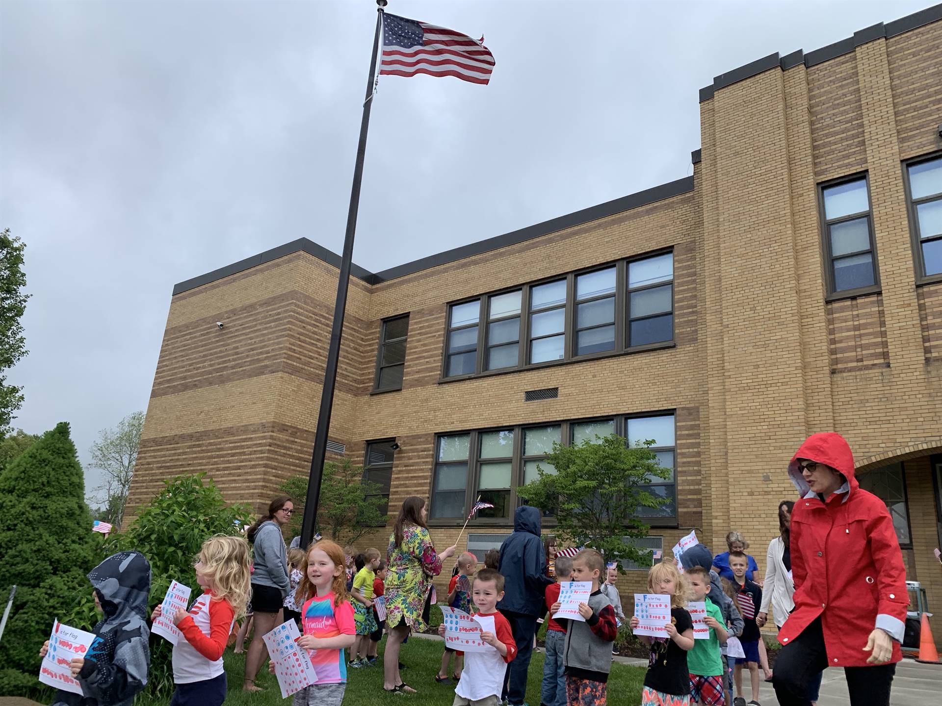 Students celebrate flag dat around the flag pole.