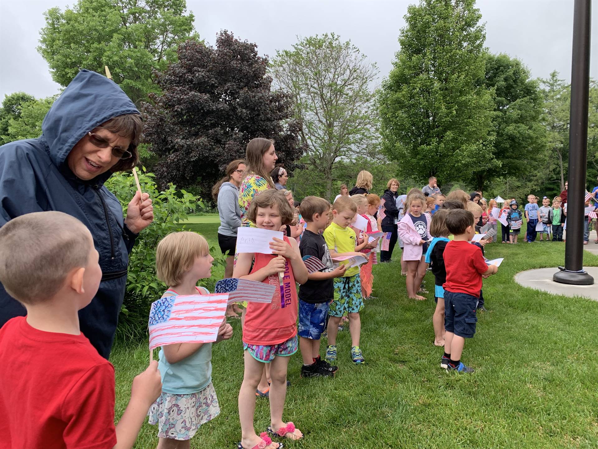 Students celebrate flag dat around the flag pole.