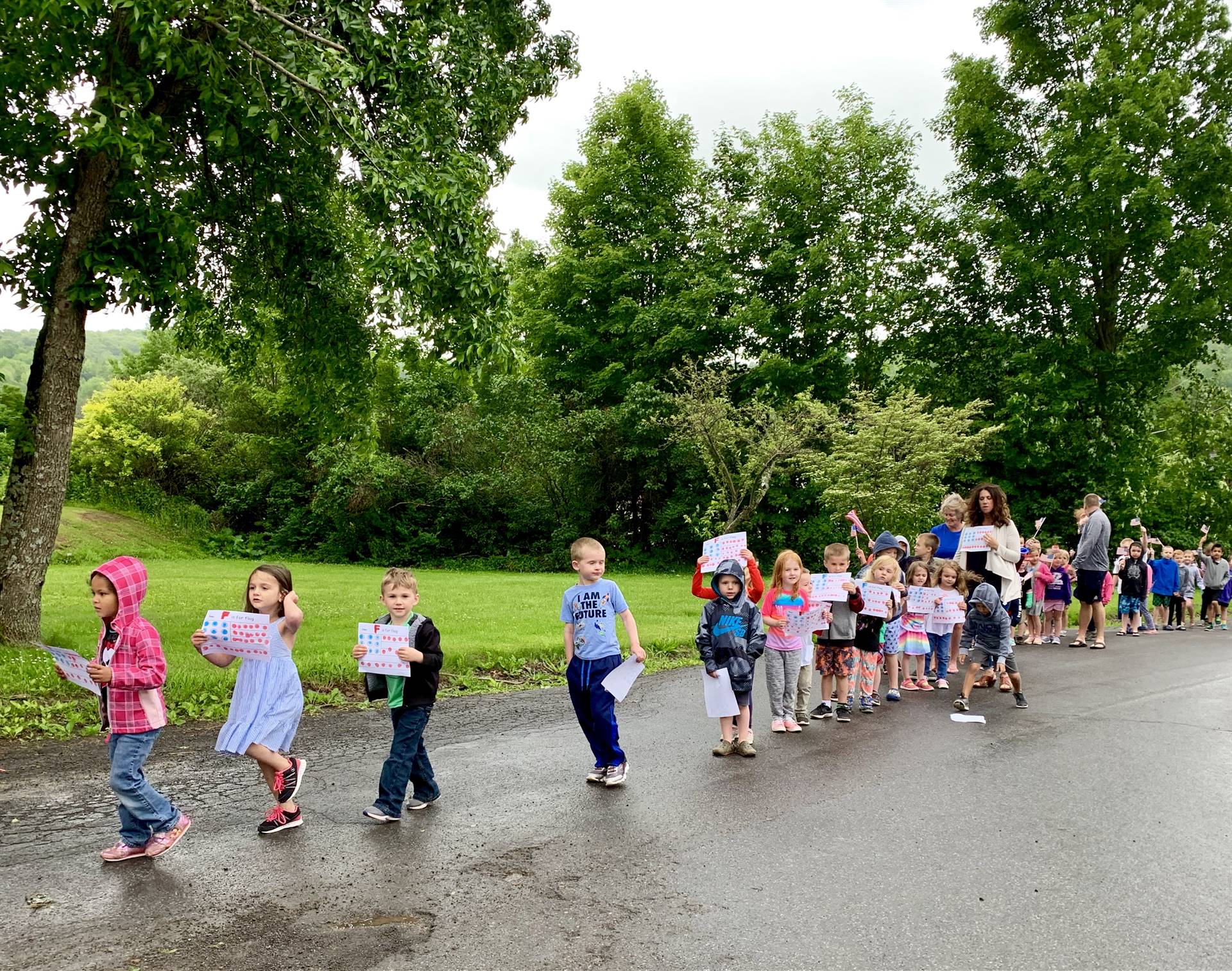 Students hold flags and march.