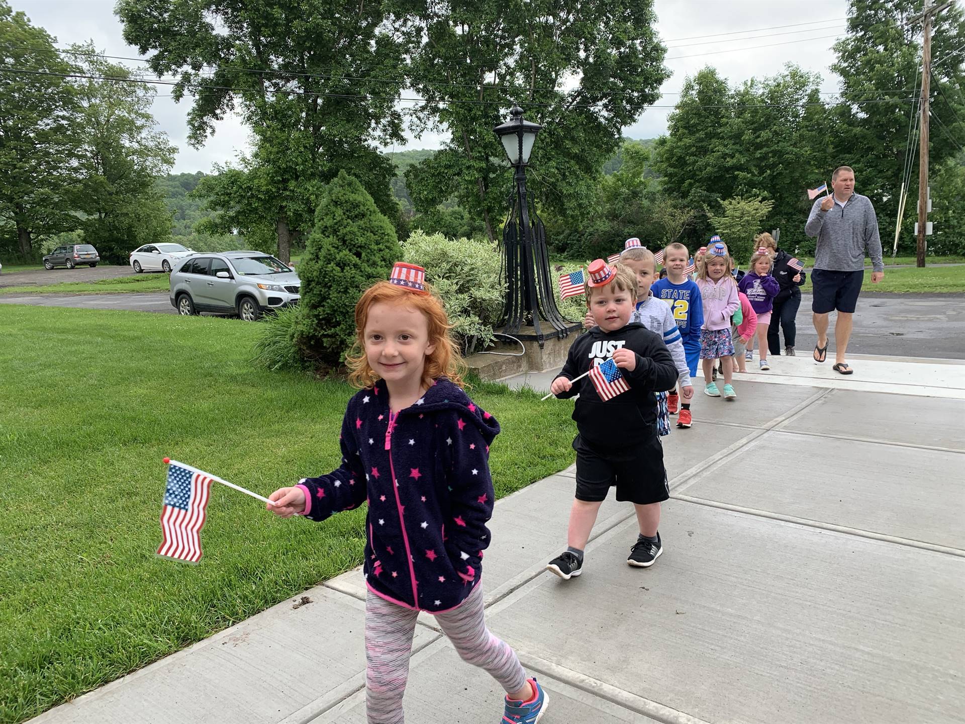 Students hold up flags and march.