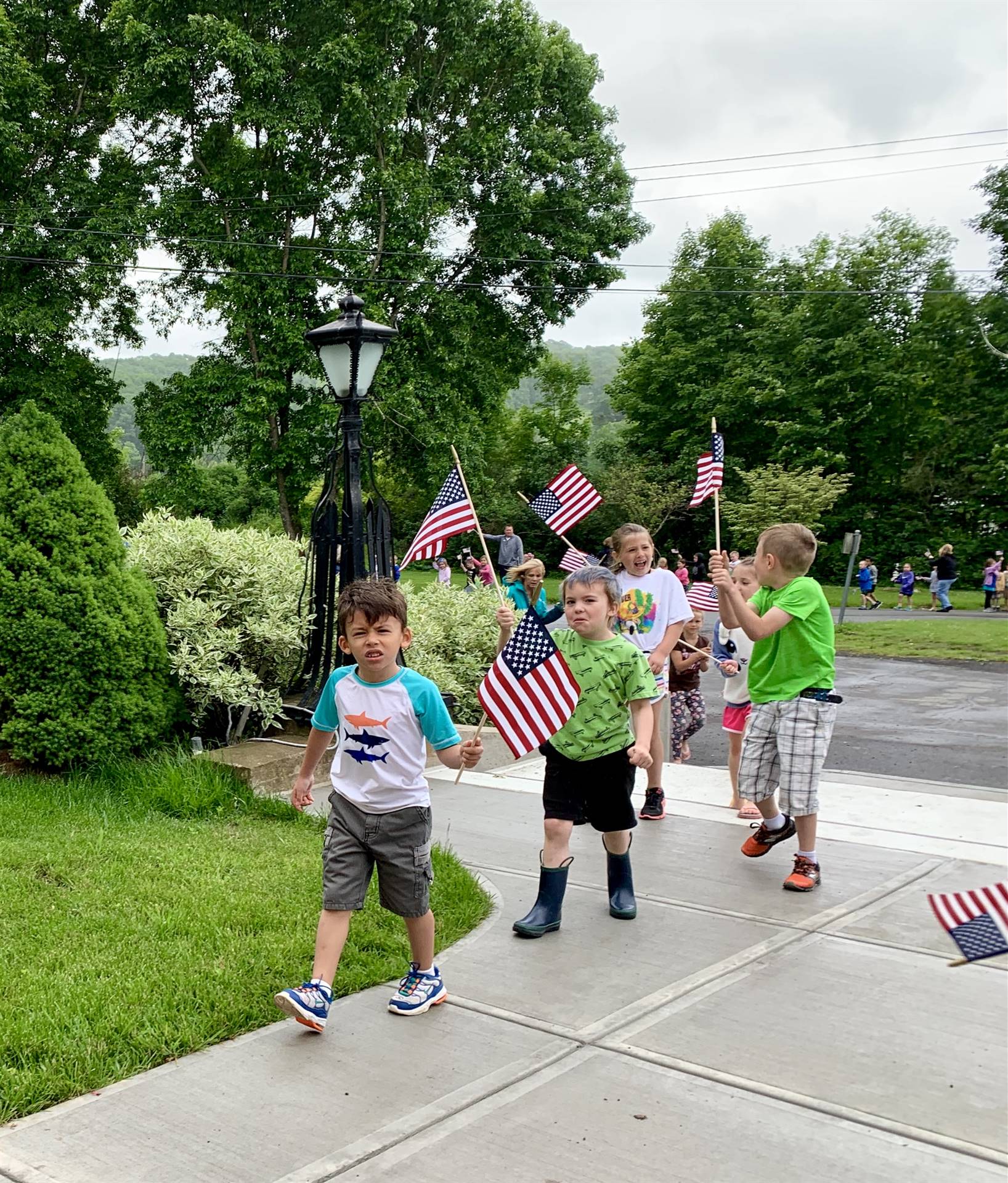 Students hold up flags and march.