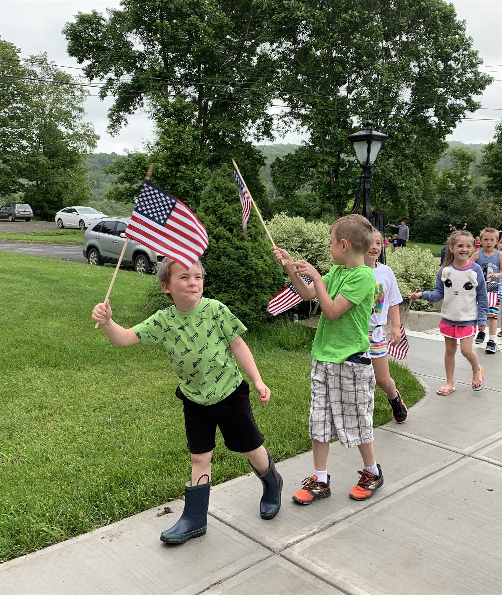 Students hold up flags and march.