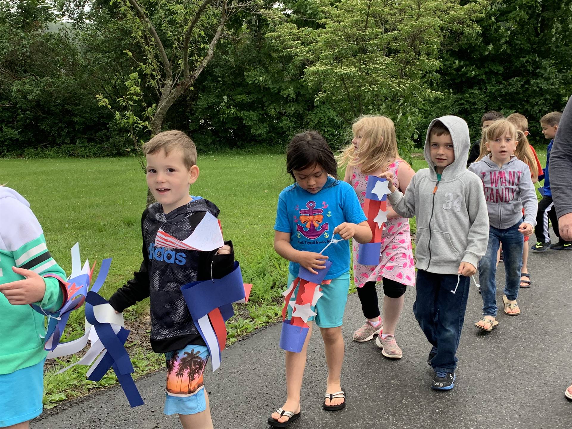 students and staff march in flag day parade.