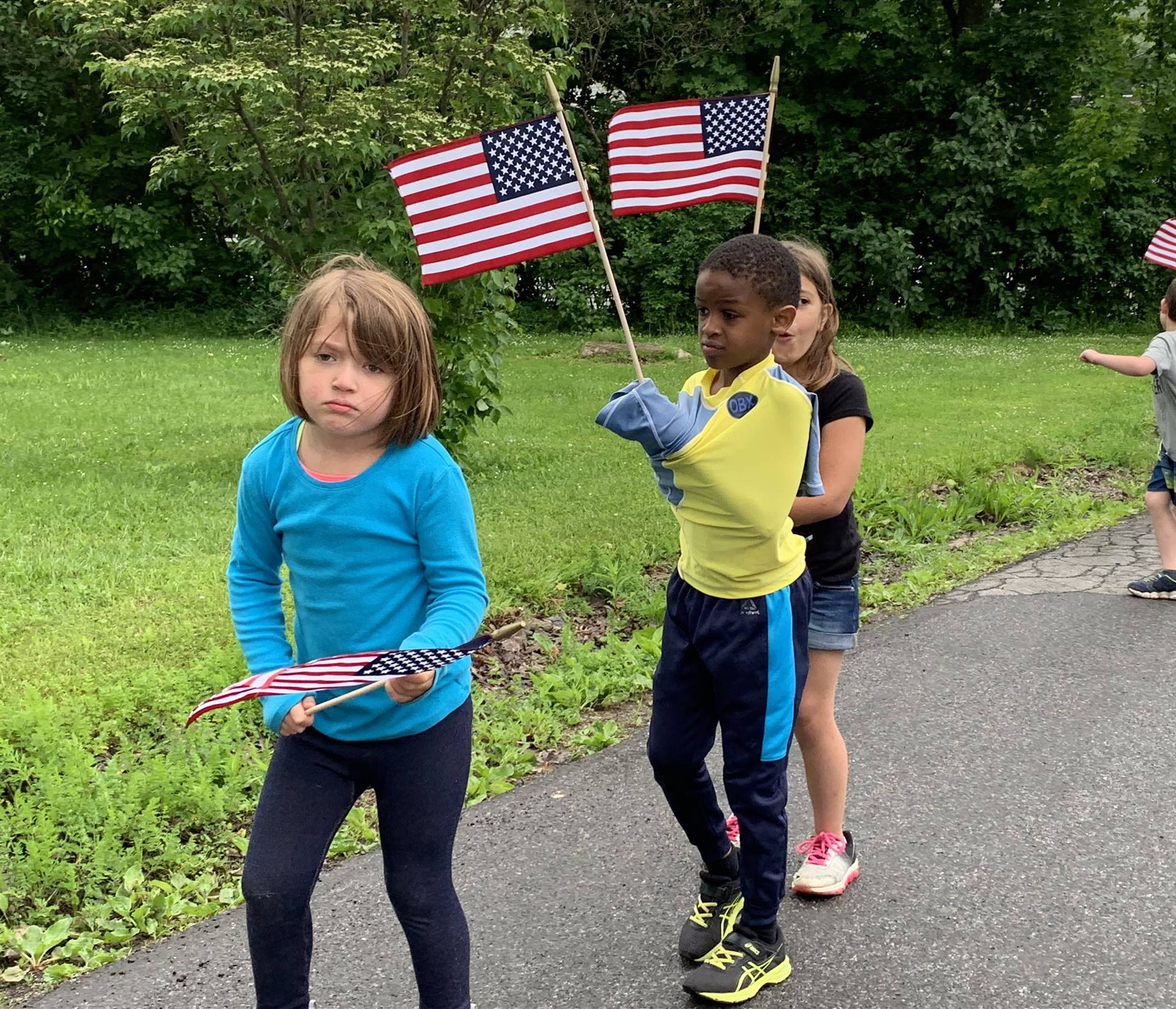 students and staff march in flag day parade.