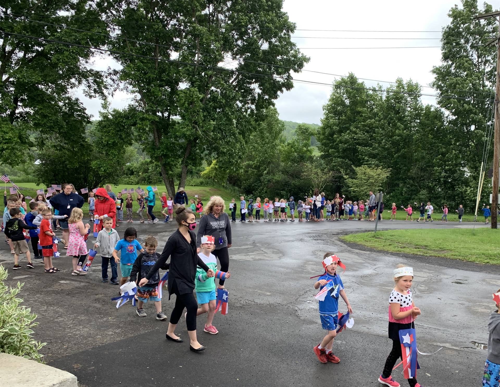 students and staff march in flag day parade.