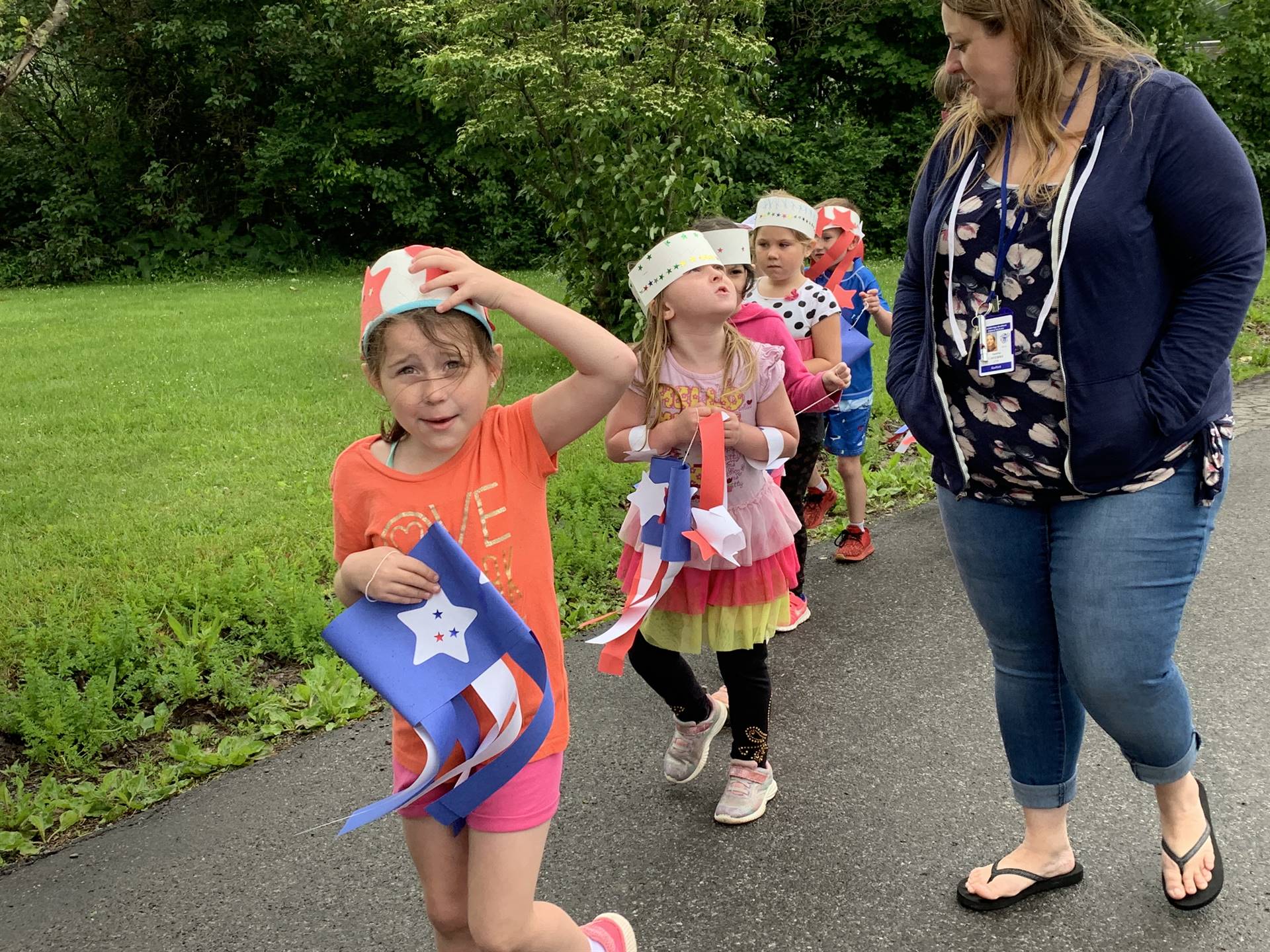 students and staff march in flag day parade.