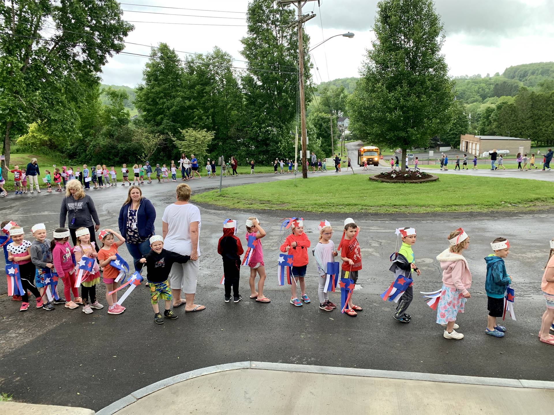 students and staff march in flag day parade.