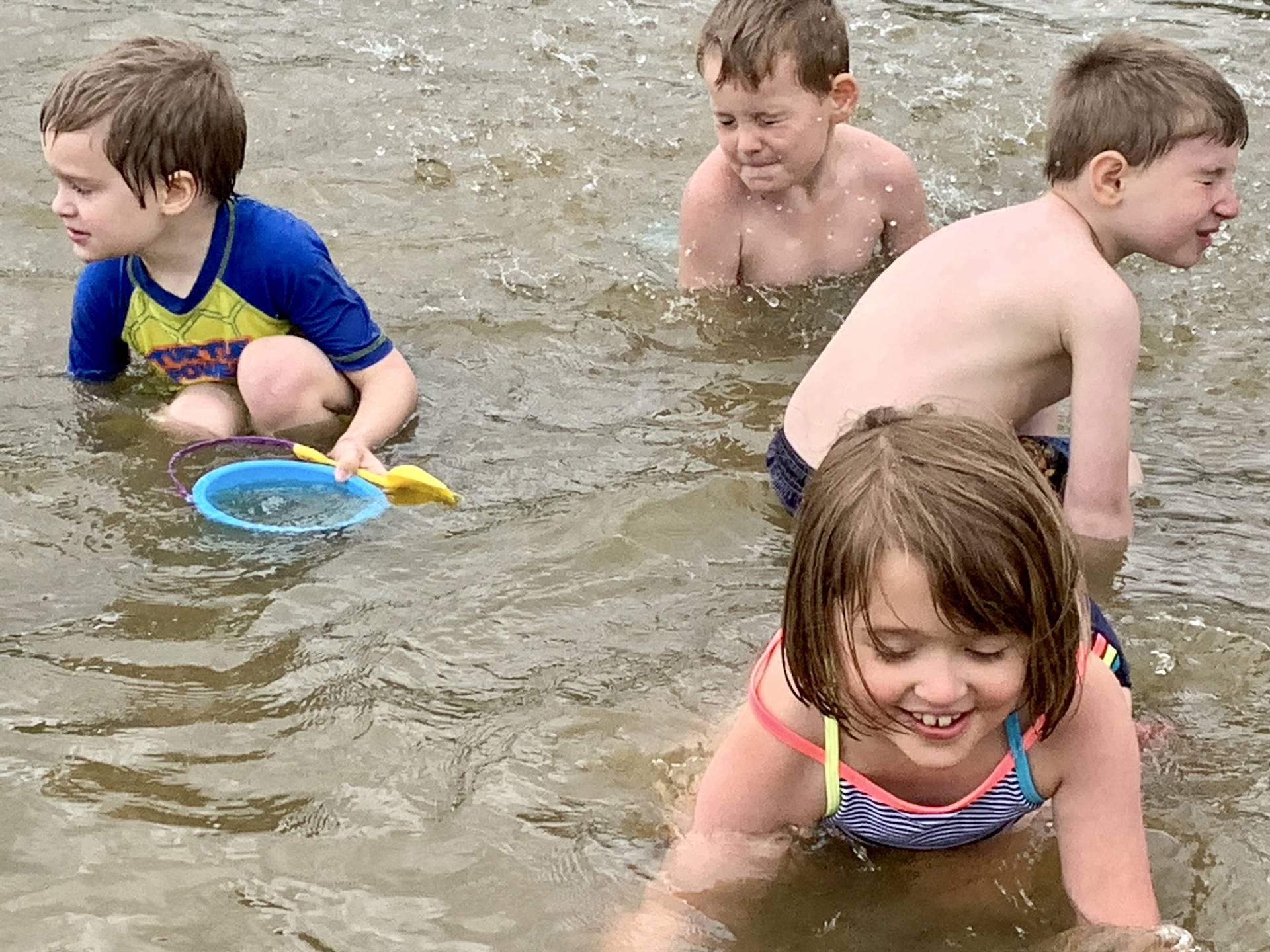 4 Students playing in the water.