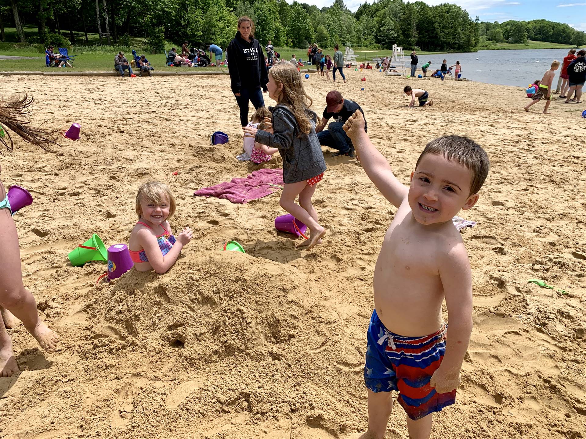 Students showing off their sand creation.