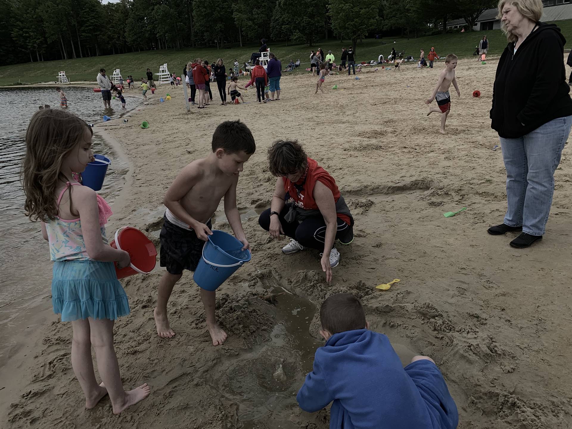 students play in sand.