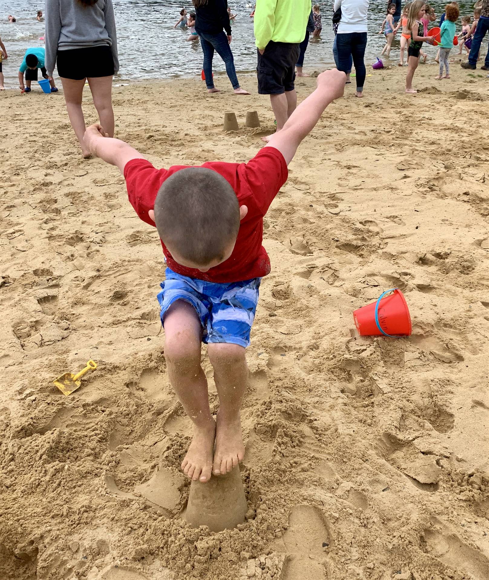 A student jumps on his sand mold!