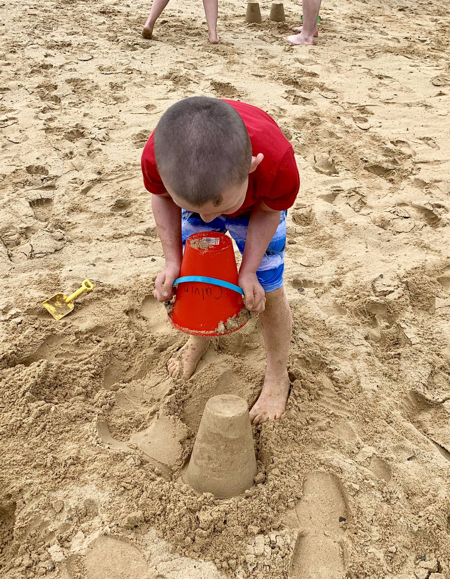 A student builds a sand castle.