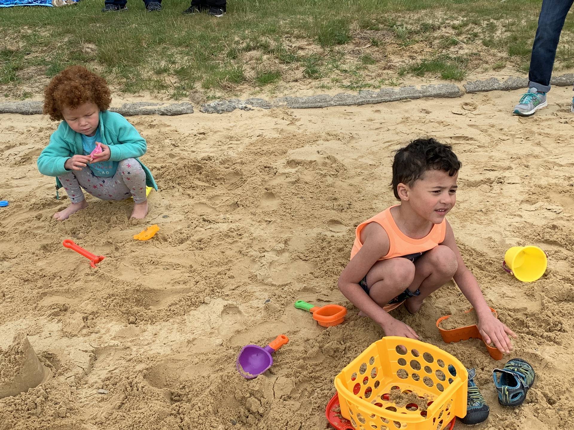 students play in sand.