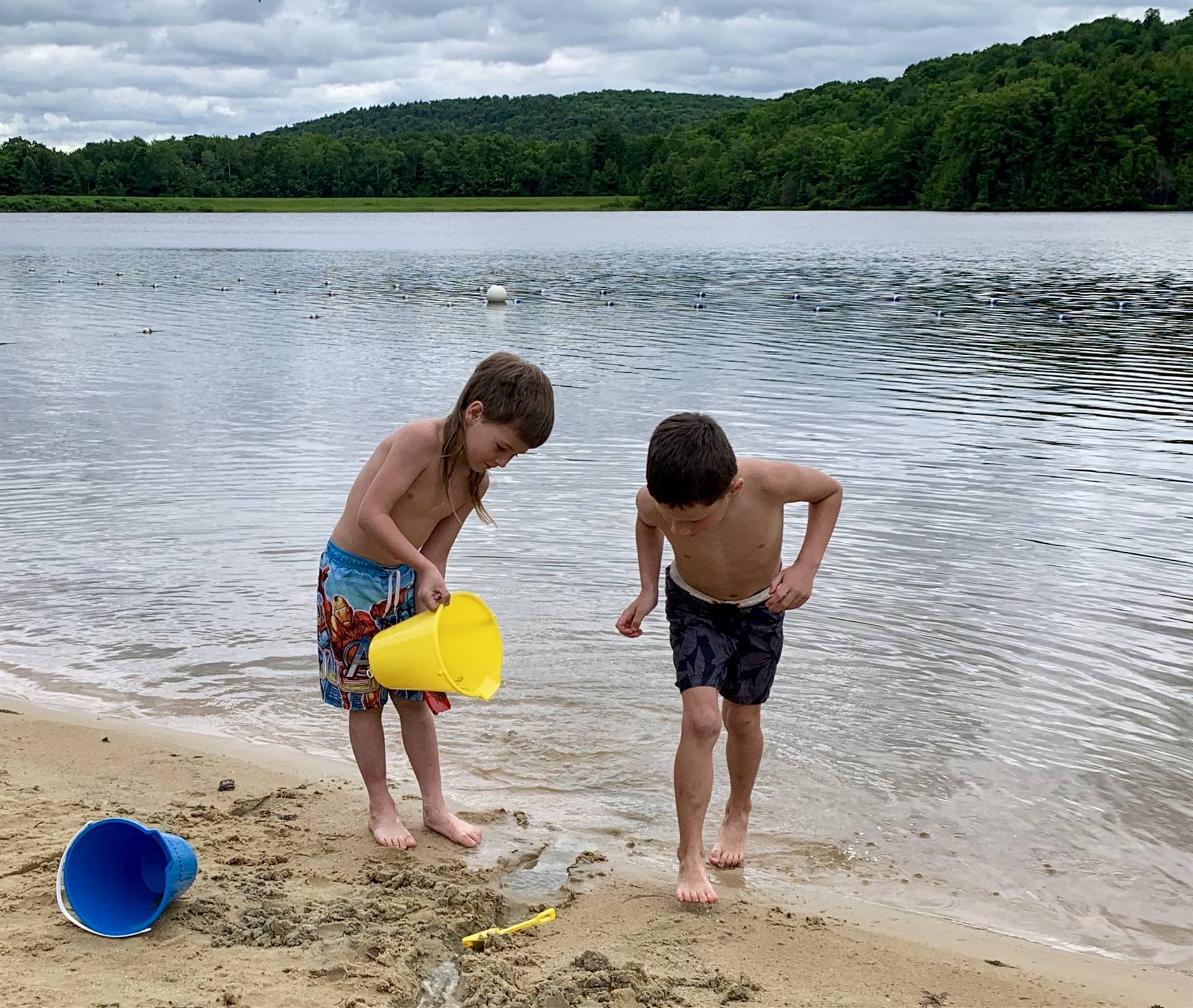 2 students pour water and watch it flow.