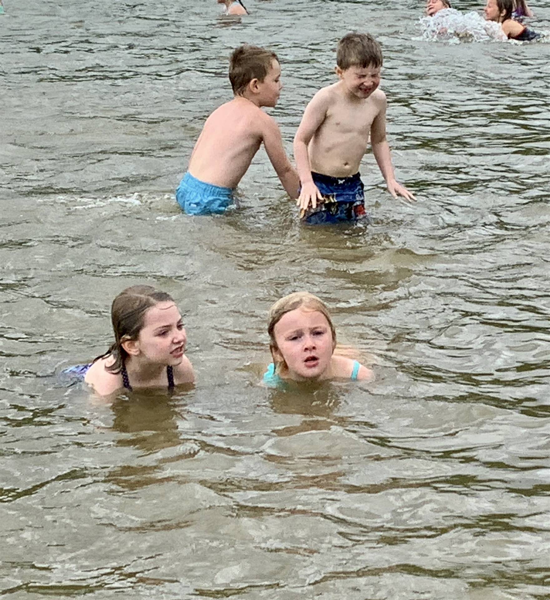 4 students in water swimming.