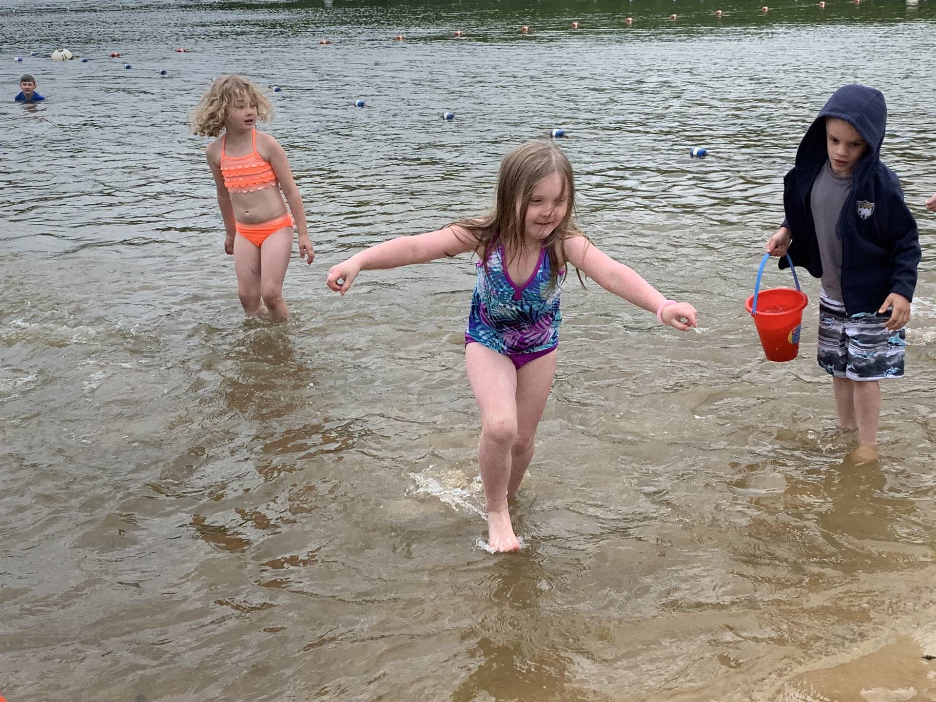 3 children playing water.