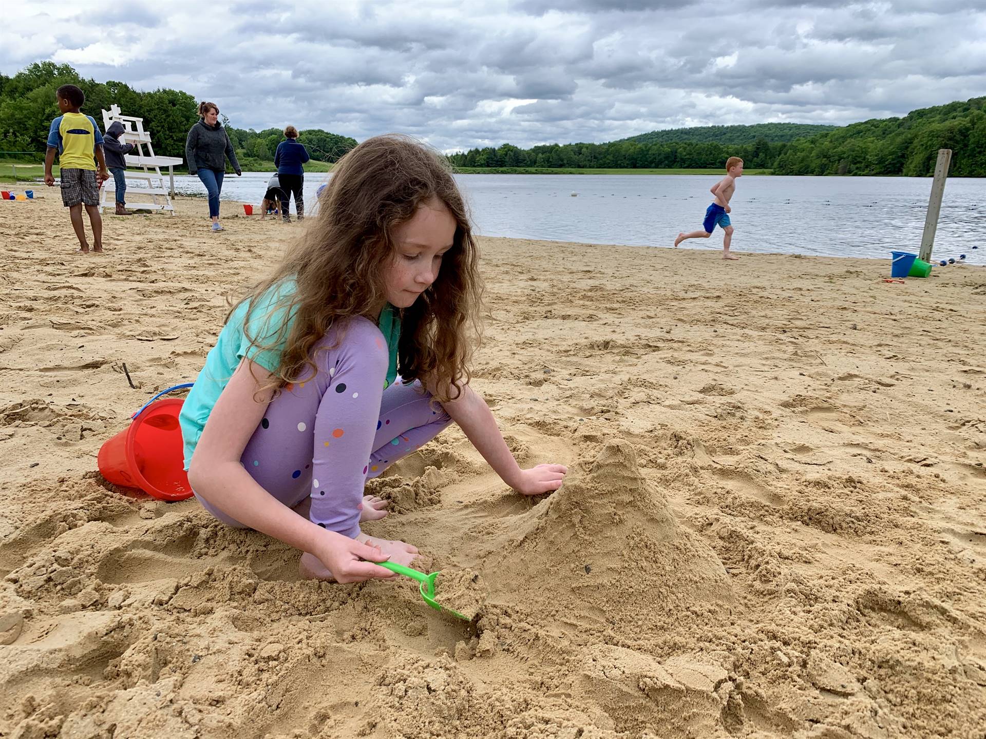 A student builds a sand castle.