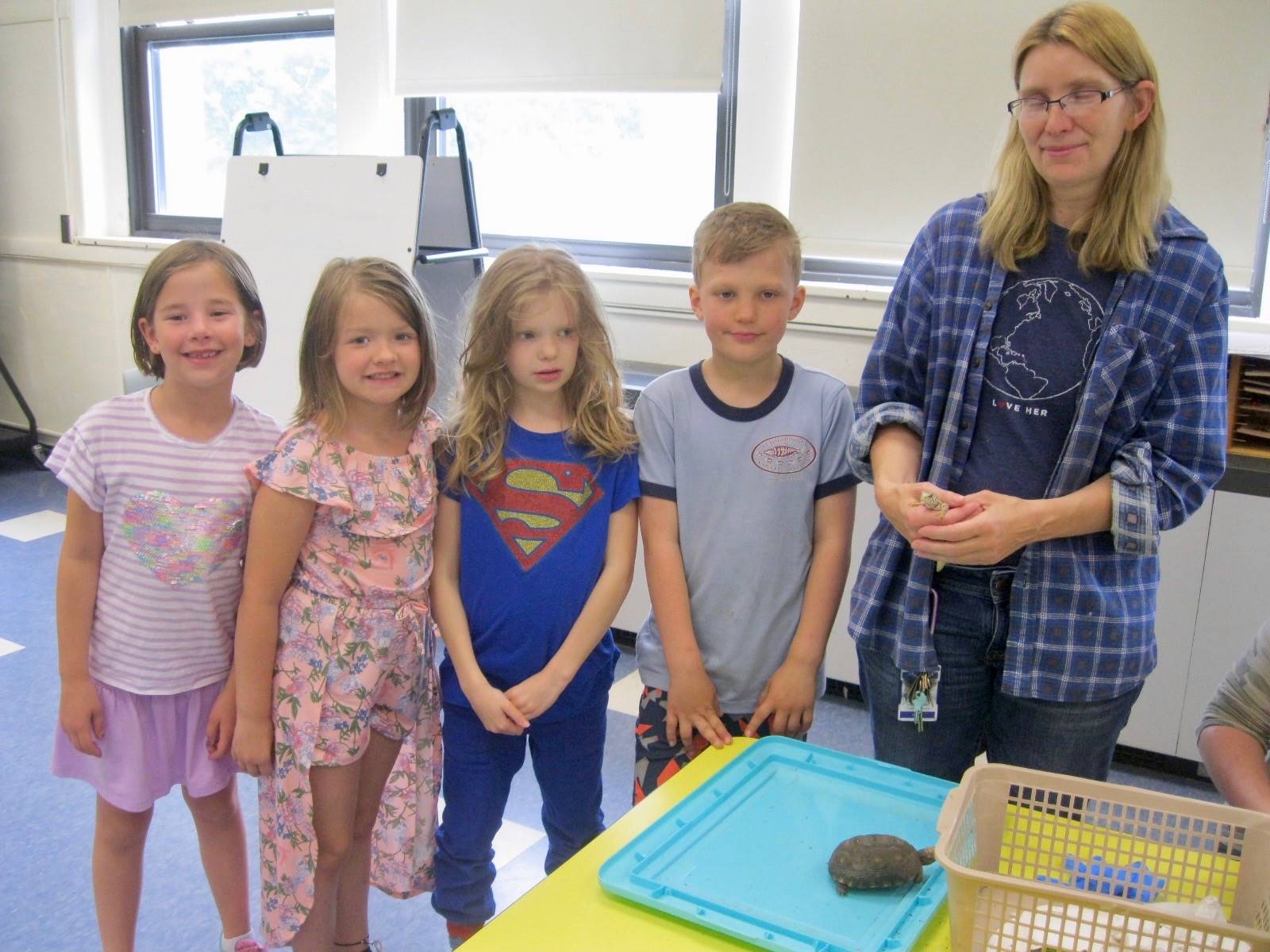 Custodian and 4 students with baby tortoise.