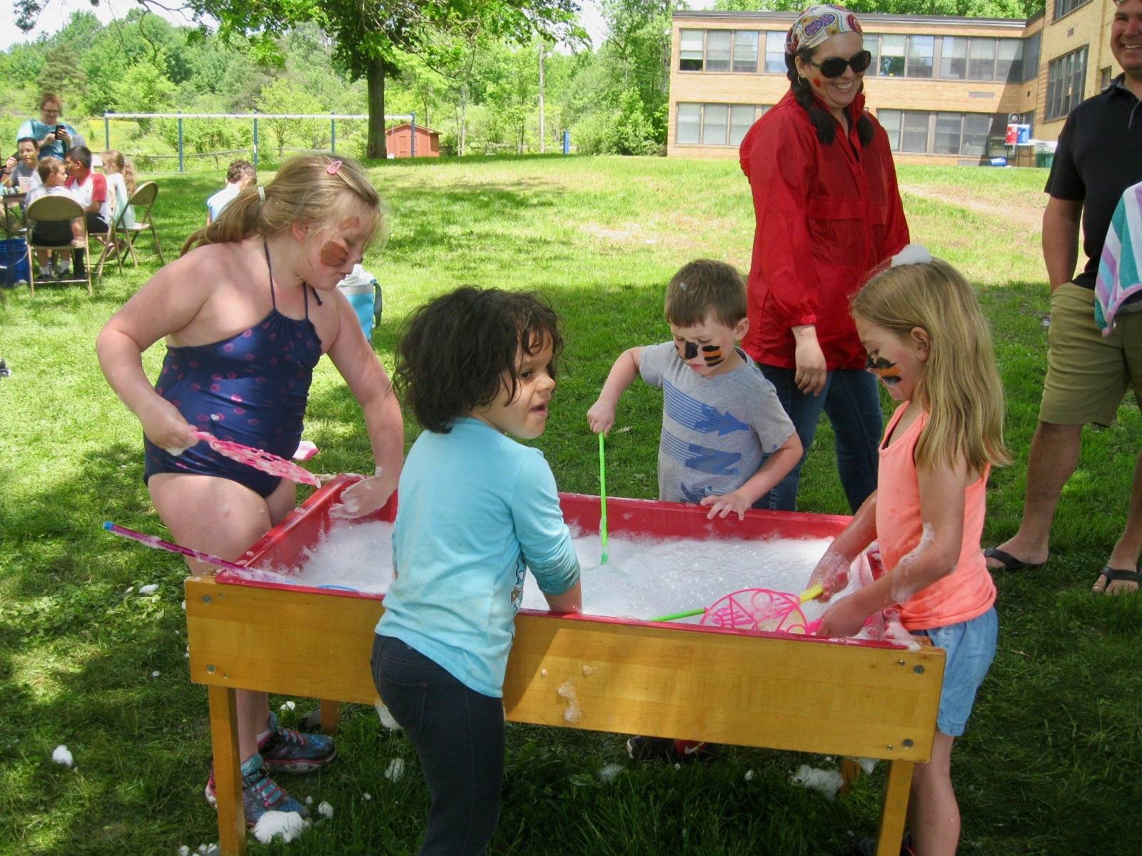 A group of students play bubbles.