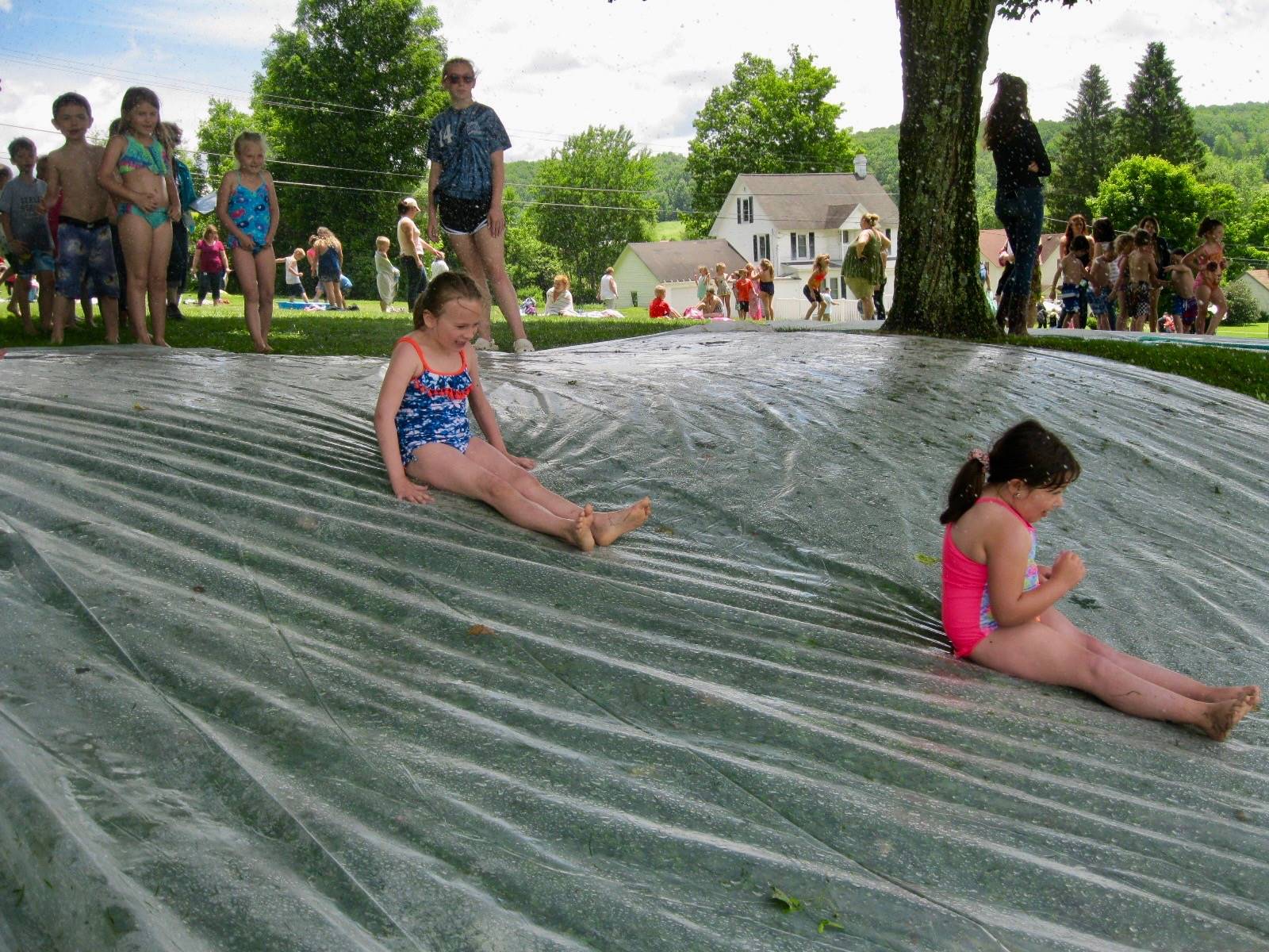 2 students on water slide.