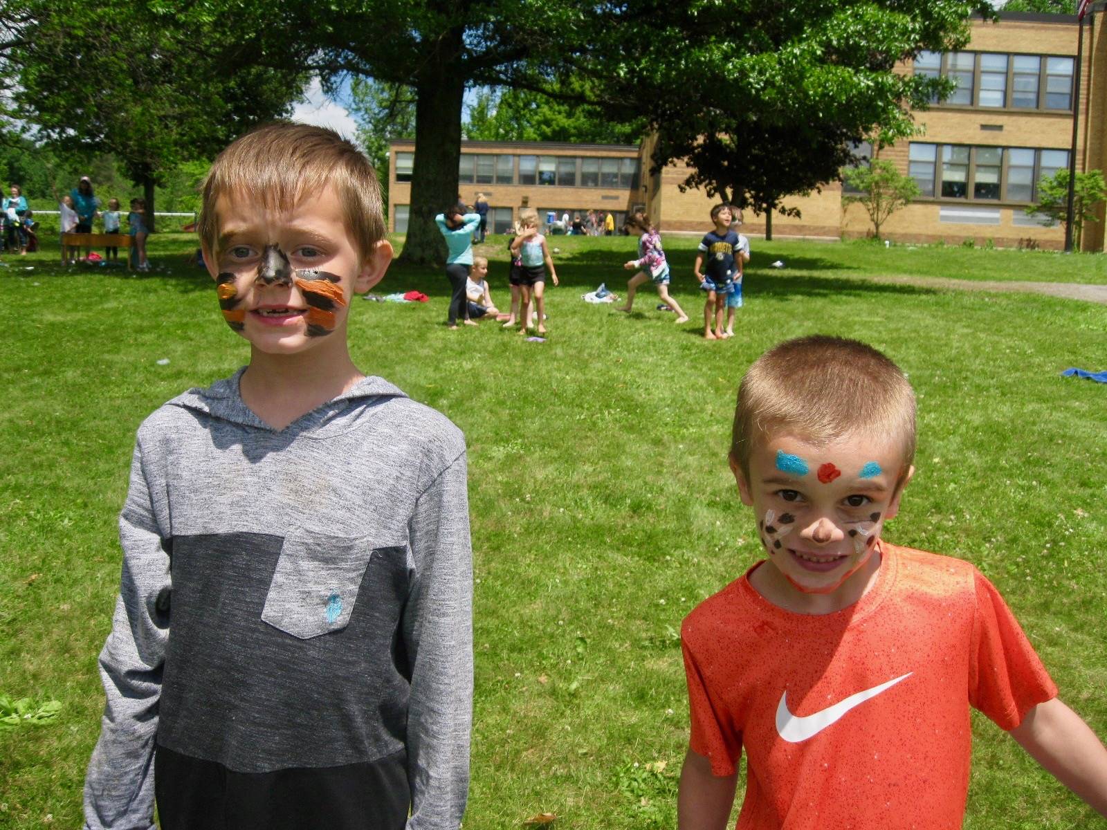 2 students with faces painted.
