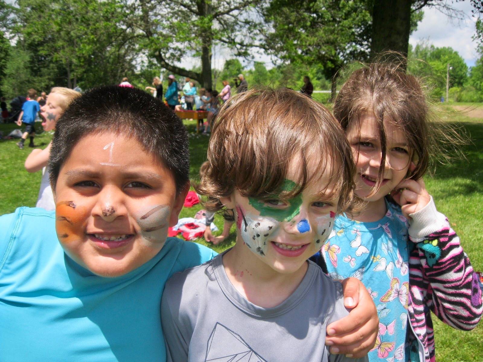 3 students with faces painted.
